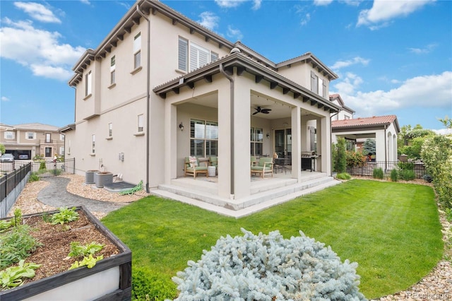 9724 Cantabria Pt, Lone Tree, CO 80124 - back of property with ceiling fan, a fenced backyard, stucco siding, a patio, and a vegetable garden