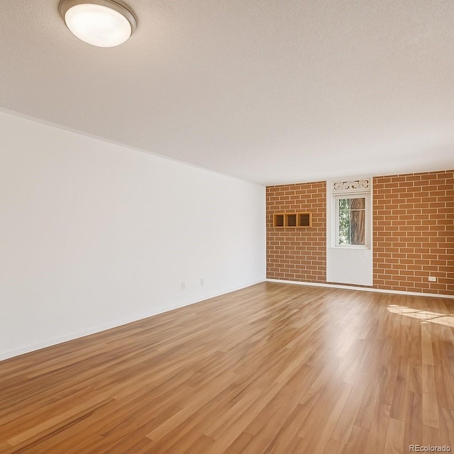 2880 S Locust St Unit 109S, Denver, CO 80222 - unfurnished living room with light wood-style flooring and a textured ceiling