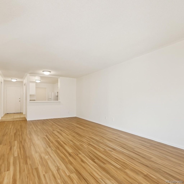2880 S Locust St Unit 109S, Denver, CO 80222 - empty room with light wood-style flooring and baseboards