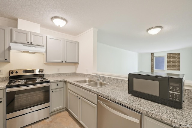 2880 S Locust St Unit 109S, Denver, CO 80222 - kitchen featuring appliances with stainless steel finishes, under cabinet range hood, a sink, light countertops, and light tile patterned flooring