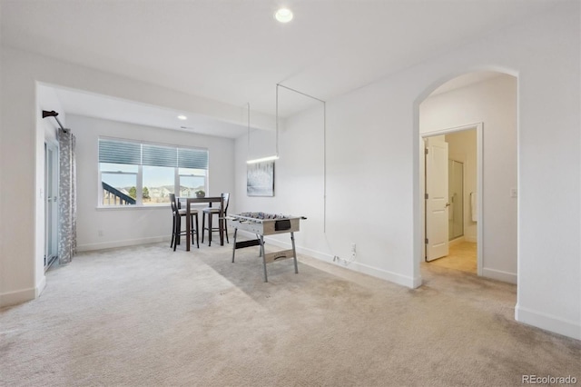 interior space with carpet, arched walkways, baseboards, and recessed lighting