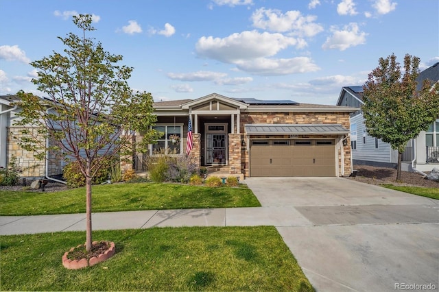 view of front of house featuring driveway, a garage, solar panels, stone siding, and a front yard