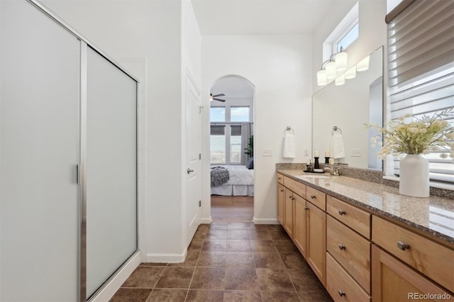 bathroom featuring ensuite bathroom, ceiling fan, tile patterned flooring, vanity, and a shower stall