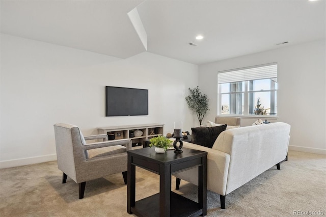 living area featuring baseboards, visible vents, vaulted ceiling, and light colored carpet