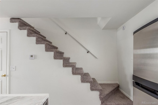3281 S Estes St, Lakewood, CO 80227 - stairs with baseboards and carpet floors