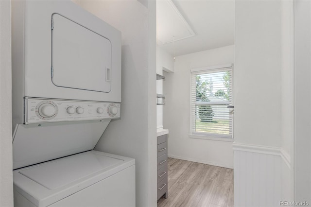 3281 S Estes St, Lakewood, CO 80227 - washroom with stacked washer / dryer, attic access, and light wood finished floors