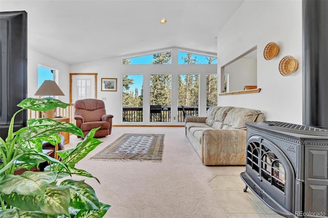 living room with light colored carpet, a wood stove, and vaulted ceiling