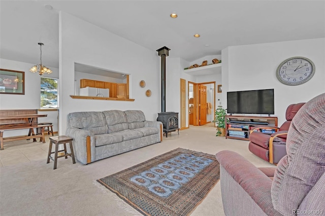 living room with light colored carpet, a wood stove, and vaulted ceiling