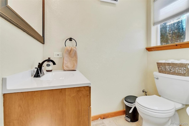 bathroom featuring tile patterned floors, vanity, and toilet