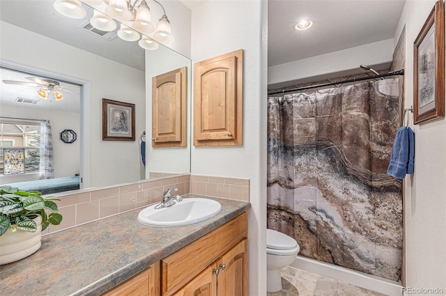 bathroom featuring a shower with shower curtain, visible vents, vanity, and toilet