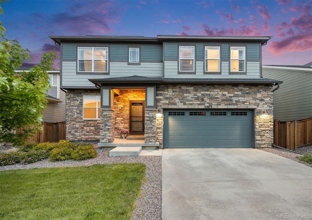 16673 E Virginia Ave, Aurora, CO 80017 - view of front of house with a garage, driveway, and stone siding