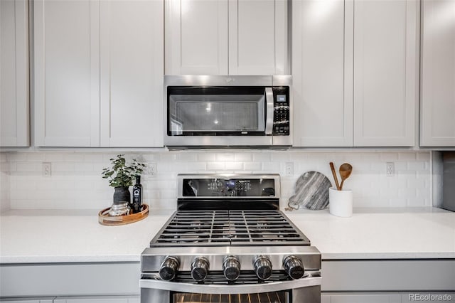 16673 E Virginia Ave, Aurora, CO 80017 - kitchen with stainless steel appliances, light countertops, and backsplash