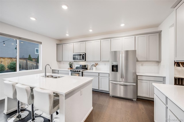 16673 E Virginia Ave, Aurora, CO 80017 - kitchen featuring appliances with stainless steel finishes, a sink, dark wood-style floors, decorative backsplash, and recessed lighting