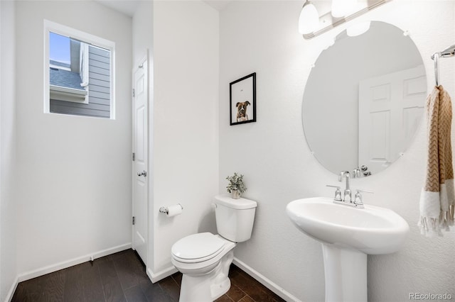 16673 E Virginia Ave, Aurora, CO 80017 - bathroom featuring wood finished floors, toilet, and baseboards