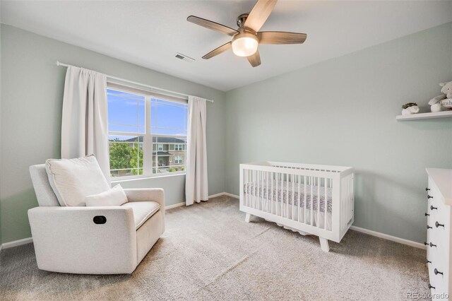 16673 E Virginia Ave, Aurora, CO 80017 - carpeted bedroom featuring a crib, baseboards, and ceiling fan