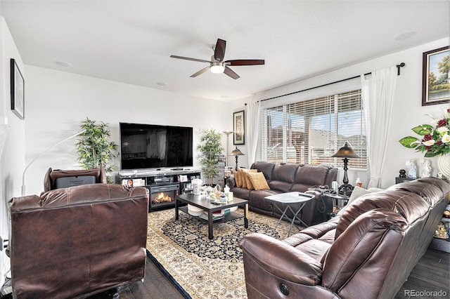 living room with a ceiling fan and wood finished floors