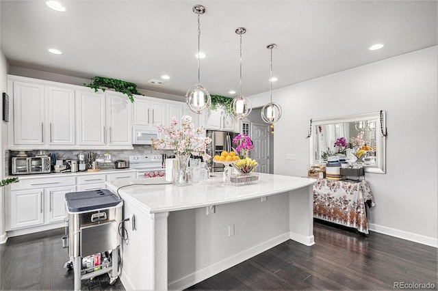 kitchen featuring white cabinets, white appliances, light countertops, and dark wood-style flooring