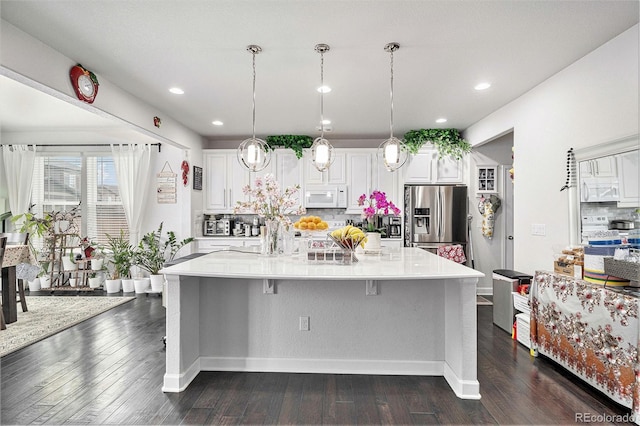 kitchen featuring backsplash, white appliances, white cabinetry, and dark wood-style flooring