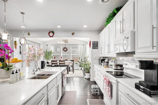 kitchen with dark wood-style floors, white appliances, white cabinets, and light countertops