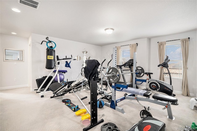 exercise area with a healthy amount of sunlight, visible vents, and baseboards