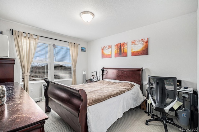 bedroom with a textured ceiling and carpet