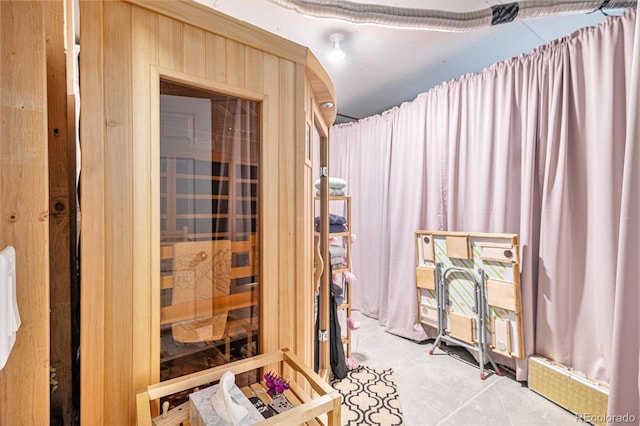 interior space with unfinished concrete flooring and a sauna