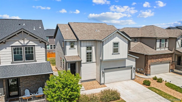 19131 E 65th Ave, Denver, CO 80249 - view of front of home featuring board and batten siding, concrete driveway, a garage, a shingled roof, and a residential view