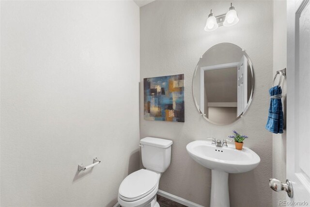 19131 E 65th Ave, Denver, CO 80249 - bathroom featuring toilet and baseboards