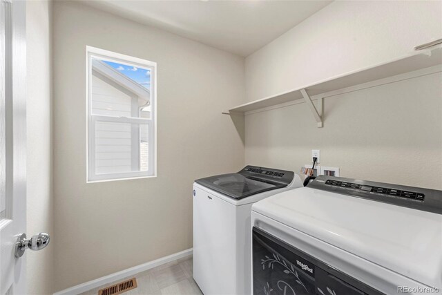 19131 E 65th Ave, Denver, CO 80249 - laundry area with separate washer and dryer and baseboards