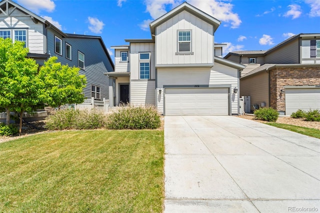 19131 E 65th Ave, Denver, CO 80249 - view of front of home featuring board and batten siding, a garage, a front yard, and driveway