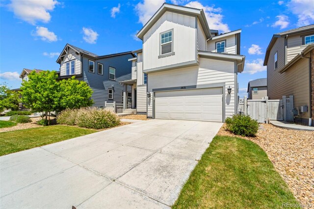 19131 E 65th Ave, Denver, CO 80249 - view of front of property with board and batten siding, a garage, concrete driveway, and a gate