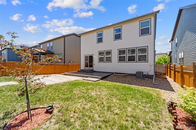 19131 E 65th Ave, Denver, CO 80249 - rear view of property with central AC unit and a patio