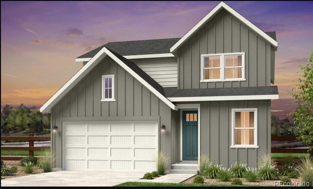16897 W 92nd Dr, Arvada, CO 80007 - view of front of house with board and batten siding, driveway, and a garage
