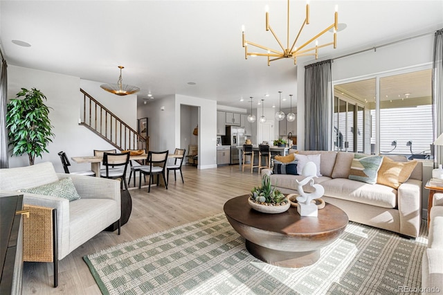 16897 W 92nd Dr, Arvada, CO 80007 - living room with a chandelier, stairs, and light wood finished floors