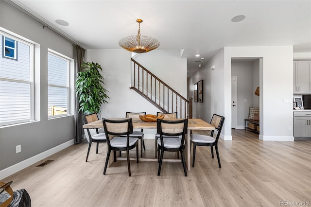 16897 W 92nd Dr, Arvada, CO 80007 - dining space with light wood-type flooring and stairs