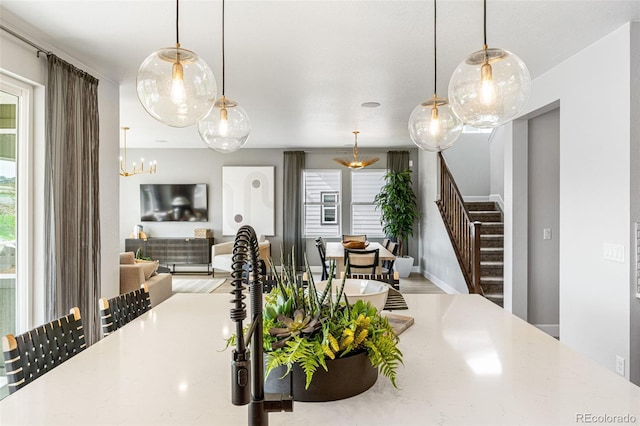 16897 W 92nd Dr, Arvada, CO 80007 - dining room with stairs, wood finished floors, and a chandelier