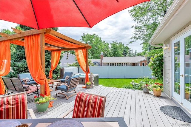 wooden terrace featuring french doors, fence, and a hot tub