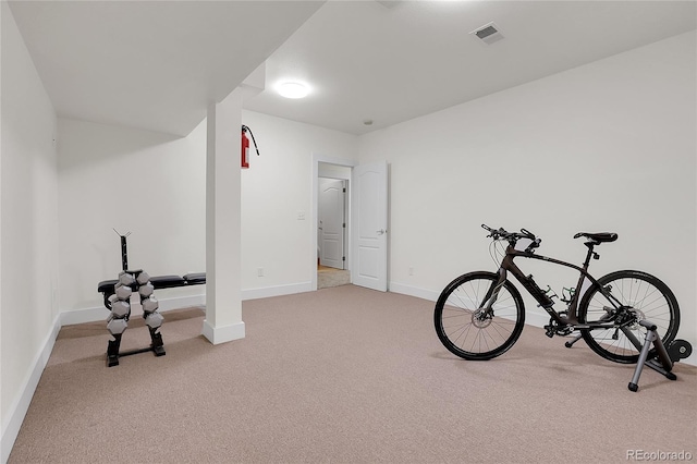 exercise room with carpet, visible vents, and baseboards