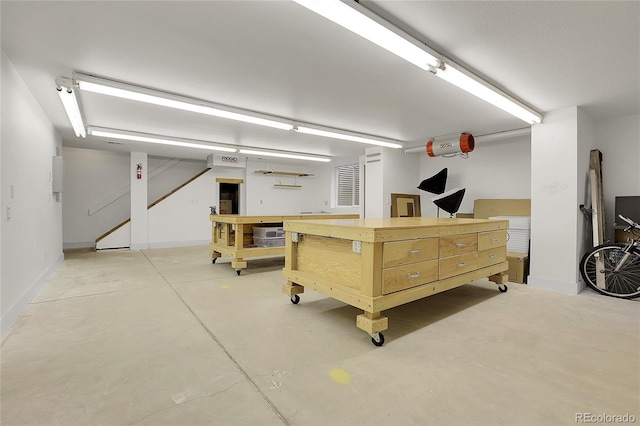 garage featuring a workshop area and baseboards