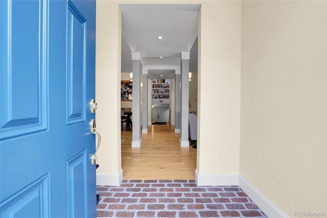 entrance foyer with brick floor, recessed lighting, and baseboards