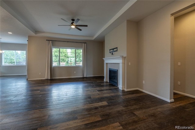 4580 S Ukraine Cir, Aurora, CO 80015 - unfurnished living room with healthy amount of natural light, ceiling fan, a raised ceiling, and a tiled fireplace