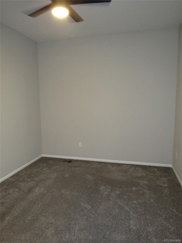 4580 S Ukraine Cir, Aurora, CO 80015 - spare room with dark carpet, a ceiling fan, and baseboards