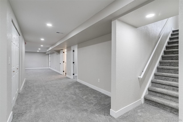 finished basement with stairs, carpet flooring, baseboards, and recessed lighting