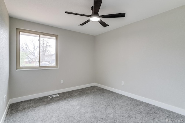 carpeted empty room featuring a ceiling fan, baseboards, and visible vents