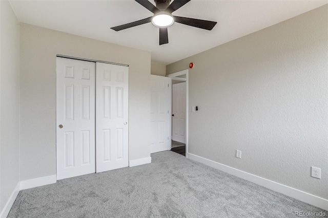 unfurnished bedroom featuring carpet floors, a closet, ceiling fan, and baseboards