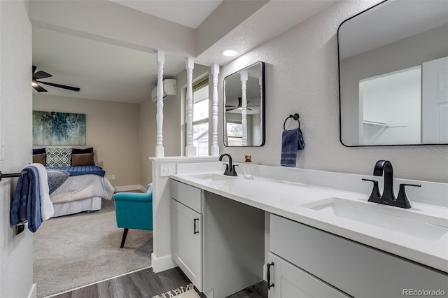 bathroom featuring ensuite bath, ceiling fan, a sink, and wood finished floors