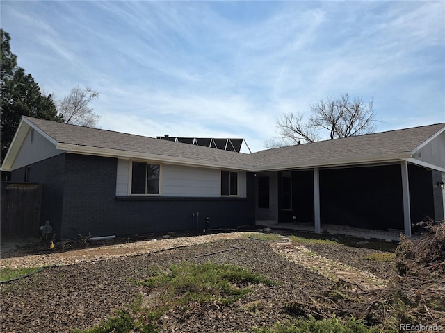 single story home featuring brick siding and a shingled roof