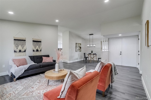 living area featuring baseboards, dark wood-style flooring, and vaulted ceiling