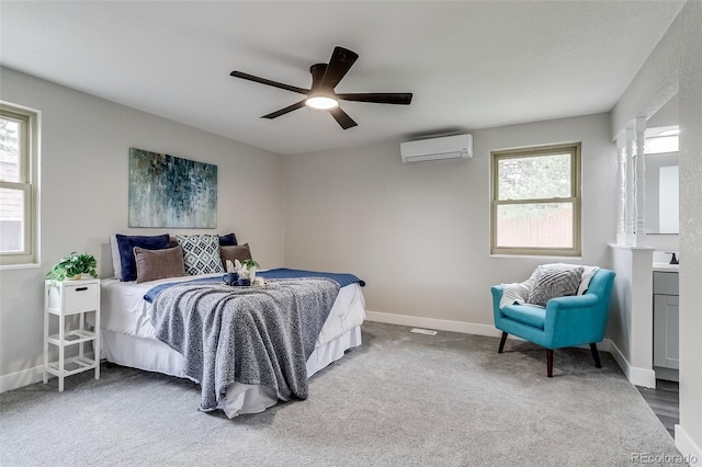 bedroom with baseboards, carpet floors, ceiling fan, and a wall mounted AC
