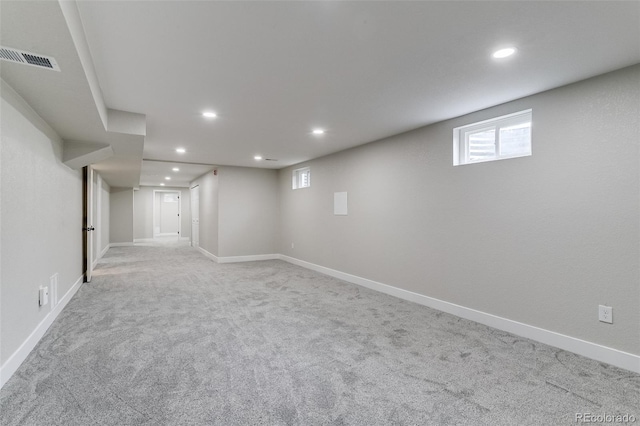 basement featuring carpet, visible vents, baseboards, and recessed lighting